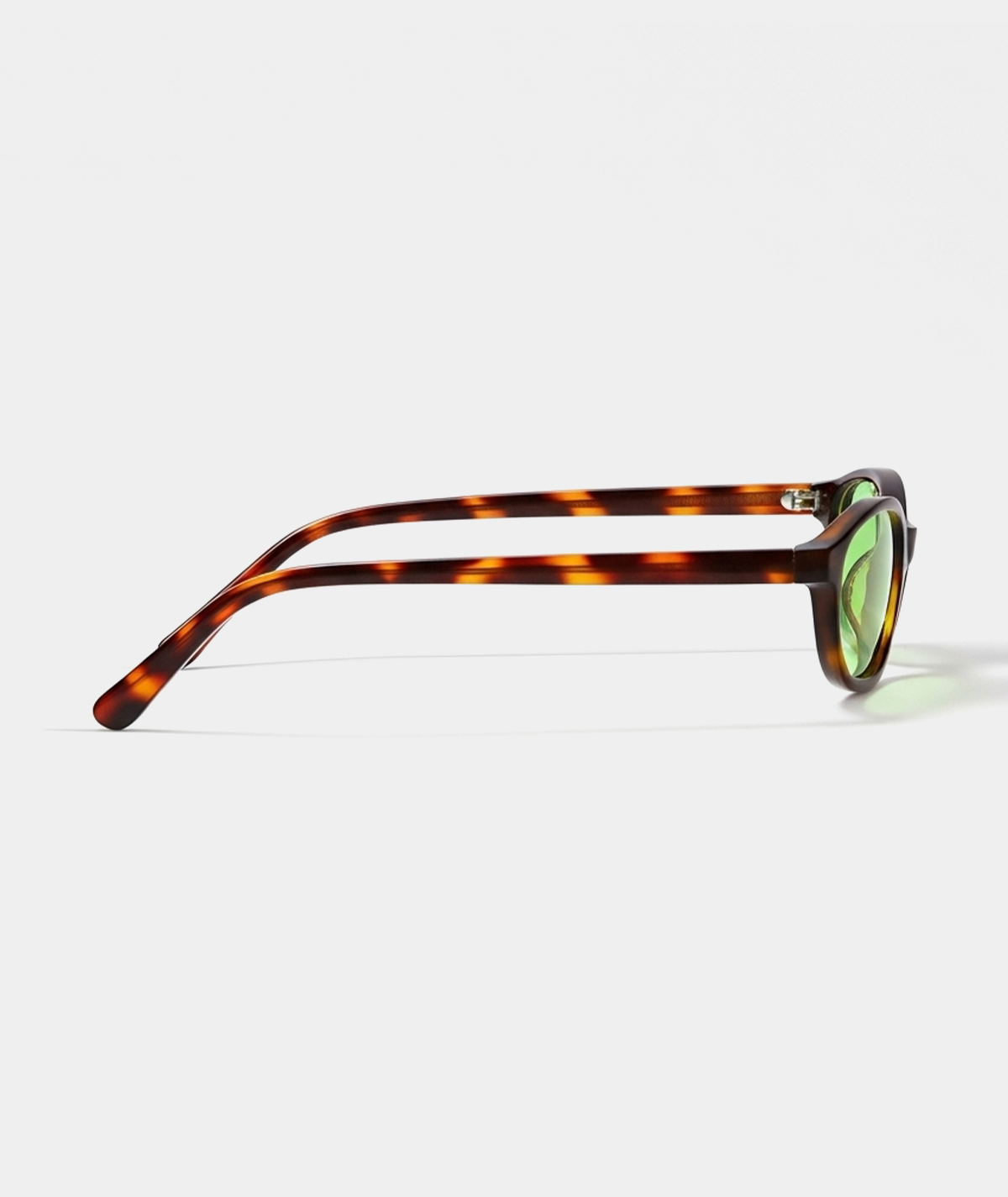 Cleo cat-eye sunglasses in tortoise with green lenses, side view