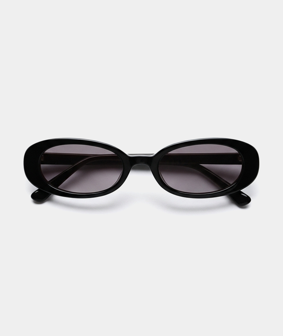 Solene oval sunglasses in black with gray lenses, front view