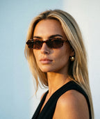 Model wearing Maelle slim rectangular sunglasses in tortoise with tea lenses